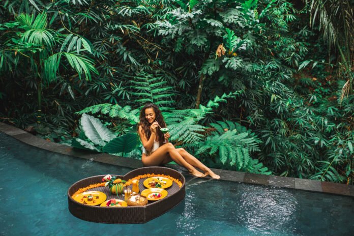 Girl,Relaxing,And,Eating,Floating,Breakfast,In,Jungle,Pool,On